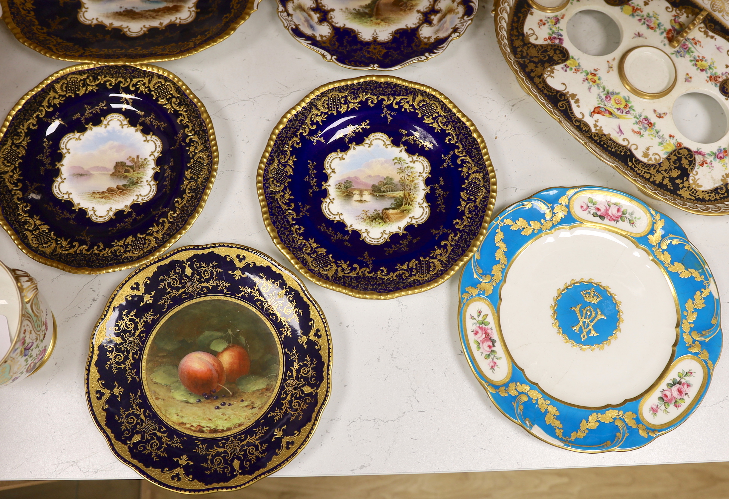 Four 19th century Coalport plates, a Coalport dish, a Minton plate, a Coalport inkstand in Chelsea style and a Derby cache pot, ink stand 40cms wide